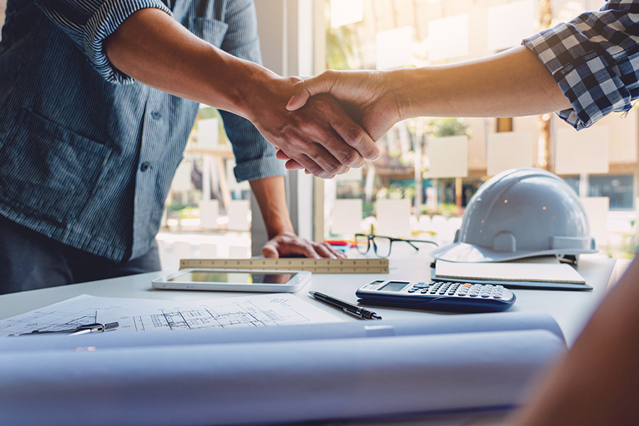 Specialized Business Insurance - Architect and Engineer Shaking Hands While Finalizing an Agreement at the Office Construction Site